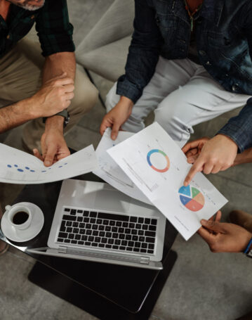 Aerial view of diverse business team analyzing financial data