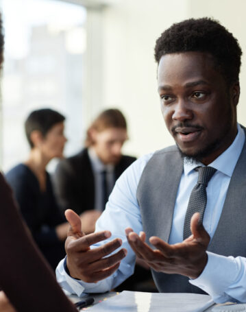 Portrait of professional black businessman consulting client at legal firm